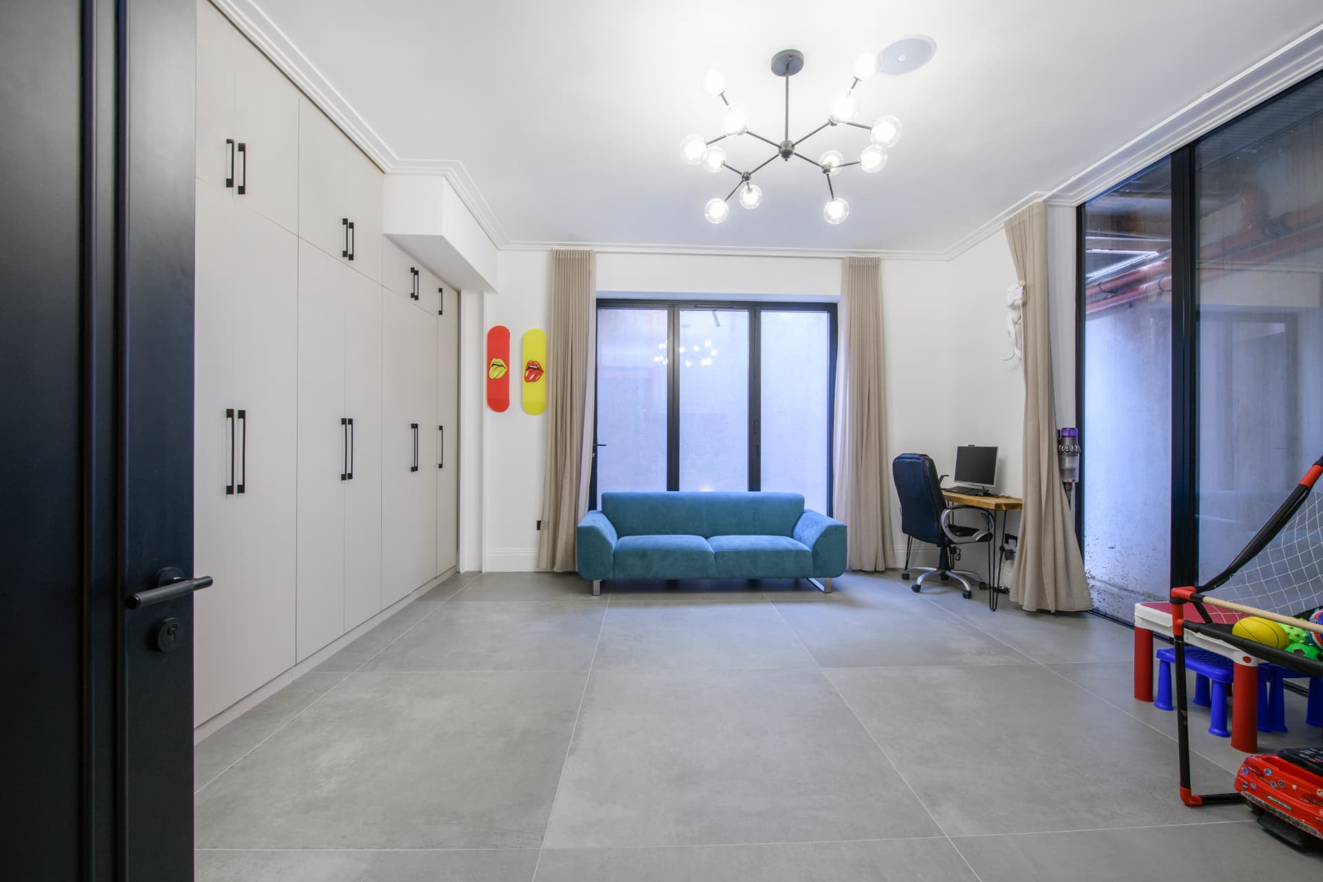 A finished basement living space with natural light wells in a North London townhouse