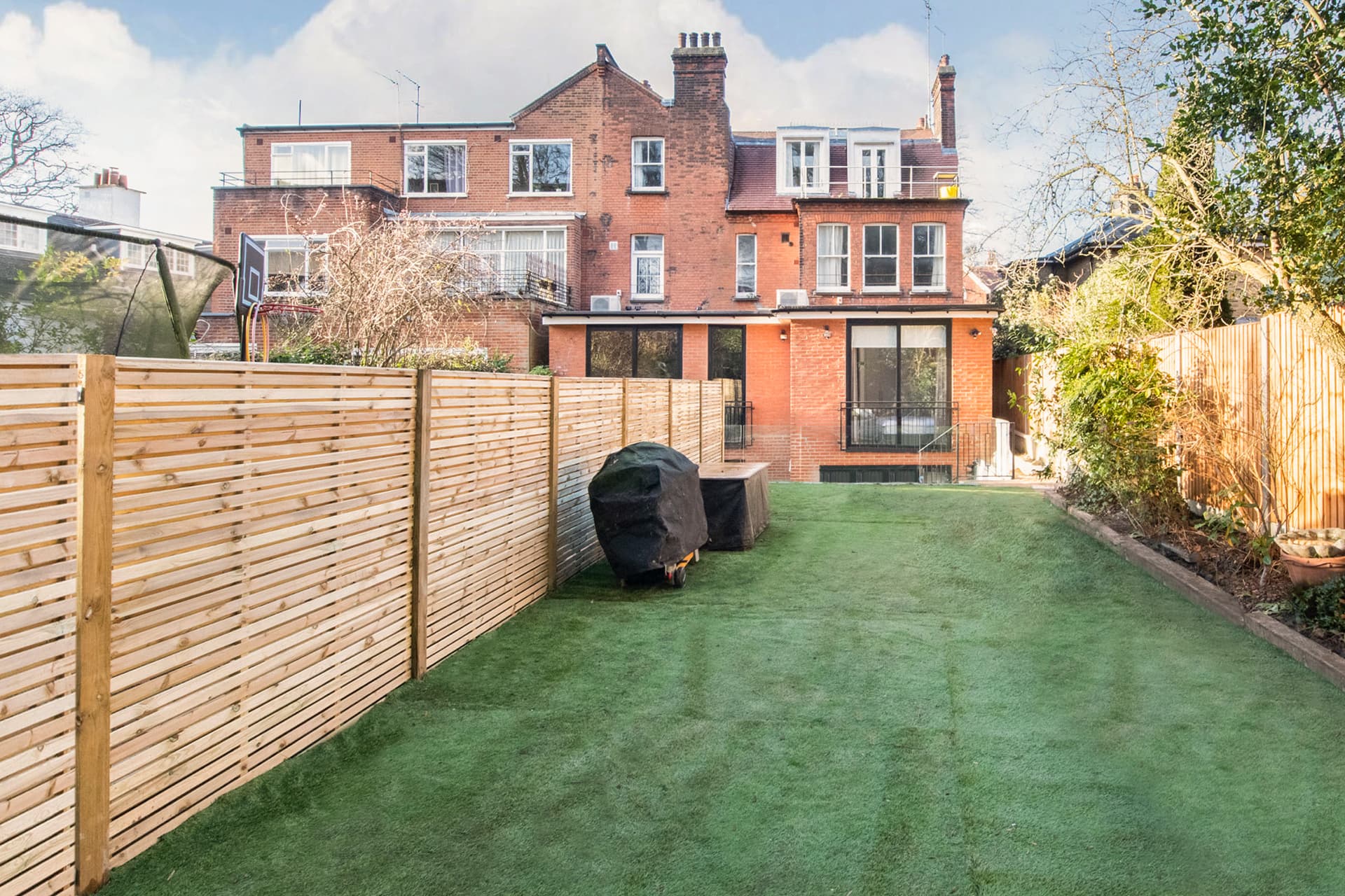 A completed rear house extension in North London with glazed doors onto the garden